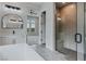 Bright bathroom showcasing a soaking tub, glass shower, double sinks, and mountain views at 11173 Concord Valley Dr, Las Vegas, NV 89135