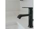 Close-up of the sink faucet with black finish and a modern design at 11173 Concord Valley Dr, Las Vegas, NV 89135