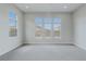 Spacious bedroom with plush carpet and a view of the mountains out the many windows at 11173 Concord Valley Dr, Las Vegas, NV 89135
