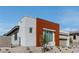 Modern home featuring a striking brown accent wall, xeriscaping, and sleek architectural design at 11173 Concord Valley Dr, Las Vegas, NV 89135