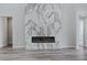 Modern fireplace with a marble accent wall adds a unique design element to the living room at 11173 Concord Valley Dr, Las Vegas, NV 89135