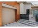 A modern style home featuring a wood paneled garage and a gated entryway at 11173 Concord Valley Dr, Las Vegas, NV 89135
