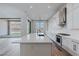 Modern kitchen features white cabinetry, a large island with quartz countertops, and stainless steel appliances at 11173 Concord Valley Dr, Las Vegas, NV 89135