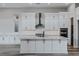 Kitchen with white cabinets, quartz countertops, stainless steel appliances, and a center island at 11173 Concord Valley Dr, Las Vegas, NV 89135
