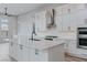 Bright kitchen with a center island, stainless steel appliances and white cabinets at 11173 Concord Valley Dr, Las Vegas, NV 89135
