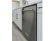 Stainless steel KitchenAid dishwasher integrated seamlessly within modern, white kitchen cabinetry at 11173 Concord Valley Dr, Las Vegas, NV 89135