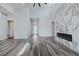Bright, open living room with luxury vinyl plank flooring and a marble fireplace wall at 11173 Concord Valley Dr, Las Vegas, NV 89135