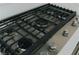Close-up of a stainless steel gas cooktop set into a quartz countertop at 11173 Concord Valley Dr, Las Vegas, NV 89135