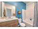 Cozy bathroom with white tiles, light wooden vanity, a plant, and modern fixtures at 1201 Dre Harbor Pl # Lot 80, North Las Vegas, NV 89084