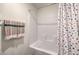 Clean bathroom with a white tiled shower/tub and a colorful polka dot shower curtain at 1201 Dre Harbor Pl # Lot 80, North Las Vegas, NV 89084