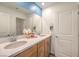 Elegant bathroom with double sinks, wood cabinets, and a large mirror with modern fixtures at 1201 Dre Harbor Pl # Lot 80, North Las Vegas, NV 89084