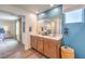 Bright bathroom with double sinks and a large mirror, offering a glimpse into the adjacent bedroom at 1201 Dre Harbor Pl # Lot 80, North Las Vegas, NV 89084