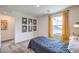 Bright bedroom featuring yellow accents, a desk area, and Pac-Personal themed artwork at 1201 Dre Harbor Pl # Lot 80, North Las Vegas, NV 89084