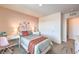Serene bedroom with pastel pink walls, a comfortable bed, and stylish floral accents at 1201 Dre Harbor Pl # Lot 80, North Las Vegas, NV 89084