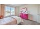 Bright bedroom featuring a pink dresser with heart decor and large window views at 1201 Dre Harbor Pl # Lot 80, North Las Vegas, NV 89084