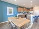 Well-lit dining area adjacent to a modern kitchen with stainless steel appliances and breakfast bar at 1201 Dre Harbor Pl # Lot 80, North Las Vegas, NV 89084