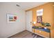 Modern entryway with a stylish console table and artwork on the orange accent wall at 1201 Dre Harbor Pl # Lot 80, North Las Vegas, NV 89084