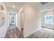 Hallway with neutral carpet leading to various rooms, featuring white walls and a window with a shade at 1201 Dre Harbor Pl # Lot 80, North Las Vegas, NV 89084
