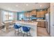 Bright kitchen with a white island, stainless steel appliances, and a cozy dining area with a wooden table at 1201 Dre Harbor Pl # Lot 80, North Las Vegas, NV 89084