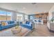 Bright living room open to the kitchen with two sofas and large windows for ample lighting at 1201 Dre Harbor Pl # Lot 80, North Las Vegas, NV 89084