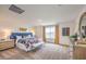 Bright main bedroom suite featuring neutral carpeting, large windows with curtains, and an elegant dresser at 1201 Dre Harbor Pl # Lot 80, North Las Vegas, NV 89084