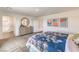 Inviting main bedroom suite with neutral carpeting, dresser, ensuite bathroom, and plenty of natural light at 1201 Dre Harbor Pl # Lot 80, North Las Vegas, NV 89084