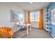 Bright office space with a white desk, peach chair, and decorative shelving and wall art at 1201 Dre Harbor Pl # Lot 80, North Las Vegas, NV 89084