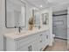 Stylish bathroom with double sinks, quartz countertops, and a glass-enclosed shower at 125 Firecreek Cir, Las Vegas, NV 89107