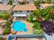 A gorgeous backyard featuring a sparkling pool, lush landscaping, covered patio, and ample space for entertaining at 1312 Fragrant Spruce Ave, Las Vegas, NV 89123