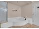 Bathroom featuring tiled floors, a shower, and a soaking tub at 1312 Fragrant Spruce Ave, Las Vegas, NV 89123