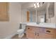 Bright bathroom with a vanity, toilet, and large mirror at 1312 Fragrant Spruce Ave, Las Vegas, NV 89123