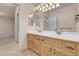 Bathroom vanity with dual sinks, granite counters and view to the shower and toilet at 1312 Fragrant Spruce Ave, Las Vegas, NV 89123
