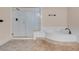 Bathroom featuring tiled floors, a shower, and a soaking tub at 1312 Fragrant Spruce Ave, Las Vegas, NV 89123