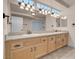 Bathroom featuring double sinks, tile flooring, a large mirror, and ample lighting at 1312 Fragrant Spruce Ave, Las Vegas, NV 89123