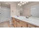 Bathroom vanity with dual sinks, granite counters and view to the tub and toilet at 1312 Fragrant Spruce Ave, Las Vegas, NV 89123