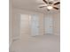 A bedroom features neutral walls, plush carpet, ceiling fan, and closet in a tranquil setting at 1312 Fragrant Spruce Ave, Las Vegas, NV 89123