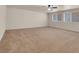 Spacious carpeted bedroom with ceiling fan and natural light from the window at 1312 Fragrant Spruce Ave, Las Vegas, NV 89123
