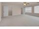 Bright bedroom featuring neutral carpeting and natural light, with easy access to closets and bathrooms at 1312 Fragrant Spruce Ave, Las Vegas, NV 89123