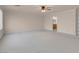 Spacious bedroom featuring neutral carpeting and a ceiling fan, offering a comfortable and inviting atmosphere at 1312 Fragrant Spruce Ave, Las Vegas, NV 89123