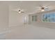 Large carpeted bedroom with ceiling fans and ample natural light from the windows at 1312 Fragrant Spruce Ave, Las Vegas, NV 89123