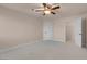 Bright bedroom with neutral carpet and ceiling fan, plus an open closet for ample storage at 1312 Fragrant Spruce Ave, Las Vegas, NV 89123