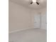 Spacious bedroom with neutral carpet, walls, ceiling fan, and two bright white doors at 1312 Fragrant Spruce Ave, Las Vegas, NV 89123