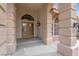 Close-up of the front door framed with stone pillars and transom window above at 1312 Fragrant Spruce Ave, Las Vegas, NV 89123