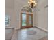 Welcoming foyer with decorative tile, chandelier, and a large wooden framed glass door at 1312 Fragrant Spruce Ave, Las Vegas, NV 89123