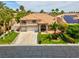 Charming two-story home with a well-manicured lawn, three-car garage, and vibrant palm trees at 1312 Fragrant Spruce Ave, Las Vegas, NV 89123