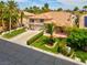 Charming two-story home with a well-manicured lawn, three-car garage, and vibrant palm trees at 1312 Fragrant Spruce Ave, Las Vegas, NV 89123