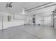 Clean three car garage featuring epoxy floor, overhead lighting, and tons of built-in storage at 1312 Fragrant Spruce Ave, Las Vegas, NV 89123