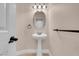Half bathroom featuring a pedestal sink, oval mirror, and neutral decor at 1312 Fragrant Spruce Ave, Las Vegas, NV 89123