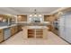 Bright kitchen featuring granite countertops, stainless steel appliances, and custom wood cabinetry at 1312 Fragrant Spruce Ave, Las Vegas, NV 89123