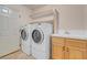 Well-equipped laundry room featuring front-load washer and dryer plus a utility sink at 1312 Fragrant Spruce Ave, Las Vegas, NV 89123